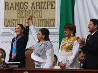 Claudia Sheinbaum Pardo, the first female President of Mexico, lifts the hand of incoming Mexico City Head of Government Clara Brugada Molin...