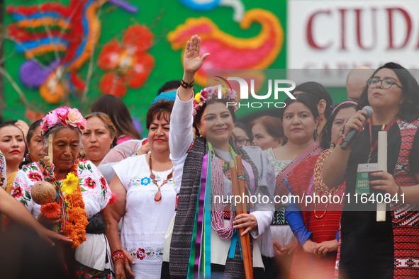 Incoming Mexico City Chief of Government Clara Brugada Molina receives the baton of command from representatives of indigenous peoples durin...