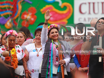 Incoming Mexico City Chief of Government Clara Brugada Molina receives the baton of command from representatives of indigenous peoples durin...