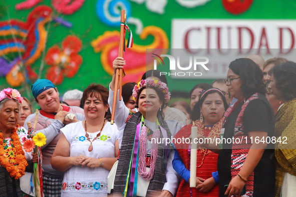 Incoming Mexico City Chief of Government Clara Brugada Molina receives the baton of command from representatives of indigenous peoples durin...