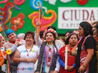 Incoming Mexico City Chief of Government Clara Brugada Molina receives the baton of command from representatives of indigenous peoples durin...