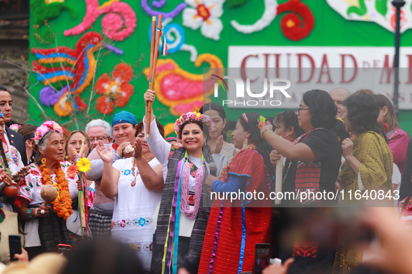 Incoming Mexico City Chief of Government Clara Brugada Molina receives the baton of command from representatives of indigenous peoples durin...