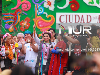 Incoming Mexico City Chief of Government Clara Brugada Molina receives the baton of command from representatives of indigenous peoples durin...