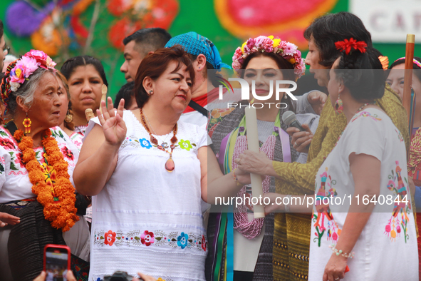 Incoming Mexico City Chief of Government Clara Brugada Molina receives the baton of command from representatives of indigenous peoples durin...