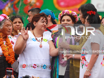 Incoming Mexico City Chief of Government Clara Brugada Molina receives the baton of command from representatives of indigenous peoples durin...