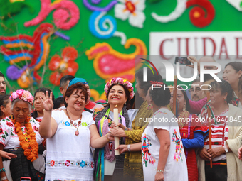 Incoming Mexico City Chief of Government Clara Brugada Molina receives the baton of command from representatives of indigenous peoples durin...