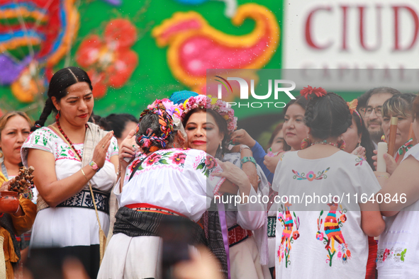 Incoming Mexico City Chief of Government Clara Brugada Molina receives the baton of command from representatives of indigenous peoples durin...