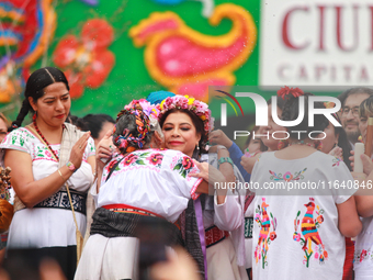 Incoming Mexico City Chief of Government Clara Brugada Molina receives the baton of command from representatives of indigenous peoples durin...