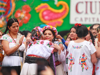 Incoming Mexico City Chief of Government Clara Brugada Molina receives the baton of command from representatives of indigenous peoples durin...