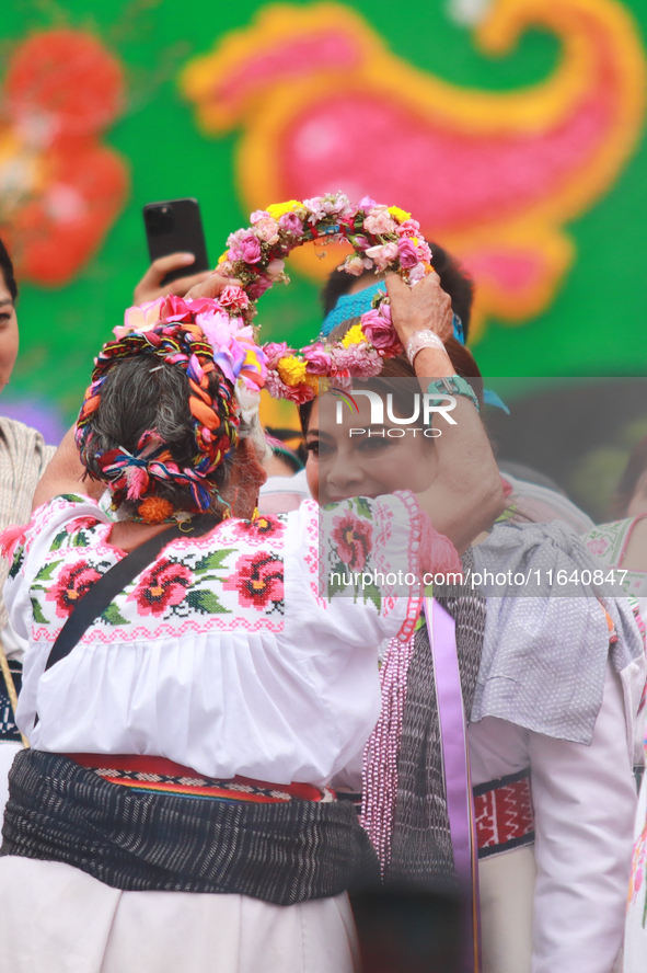 Incoming Mexico City Chief of Government Clara Brugada Molina receives the baton of command from representatives of indigenous peoples durin...