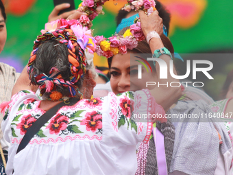 Incoming Mexico City Chief of Government Clara Brugada Molina receives the baton of command from representatives of indigenous peoples durin...