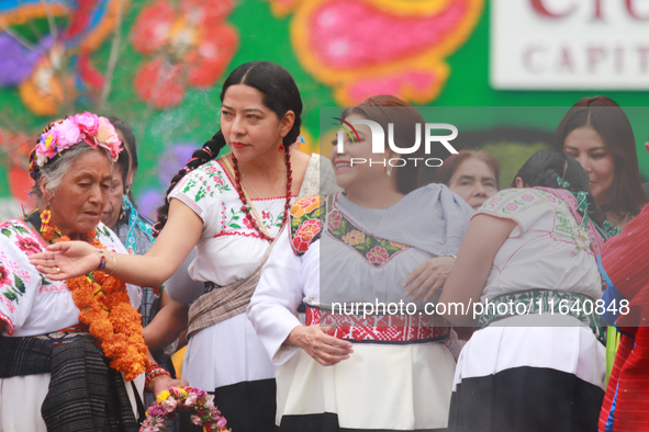 Incoming Mexico City Chief of Government Clara Brugada Molina receives the baton of command from representatives of indigenous peoples durin...