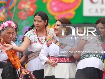 Incoming Mexico City Chief of Government Clara Brugada Molina receives the baton of command from representatives of indigenous peoples durin...