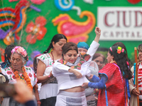 Incoming Mexico City Chief of Government Clara Brugada Molina receives the baton of command from representatives of indigenous peoples durin...