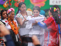 Incoming Mexico City Chief of Government Clara Brugada Molina receives the baton of command from representatives of indigenous peoples durin...