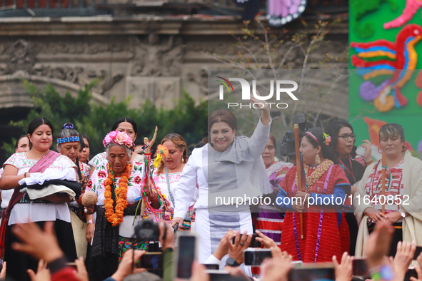 Incoming Mexico City Chief of Government Clara Brugada Molina receives the baton of command from representatives of indigenous peoples durin...