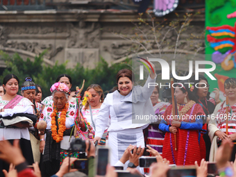 Incoming Mexico City Chief of Government Clara Brugada Molina receives the baton of command from representatives of indigenous peoples durin...