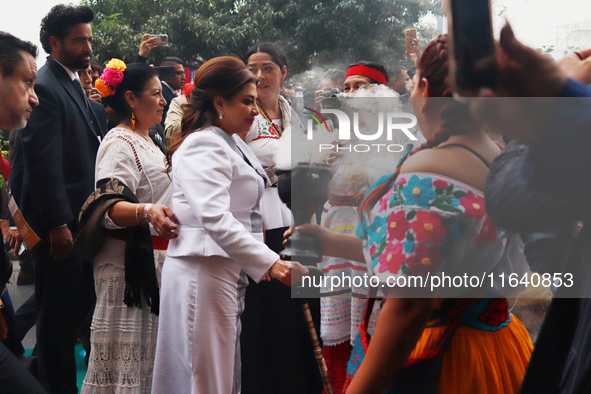 Incoming Mexico City Chief of Government Clara Brugada Molina receives the baton of command from representatives of indigenous peoples durin...