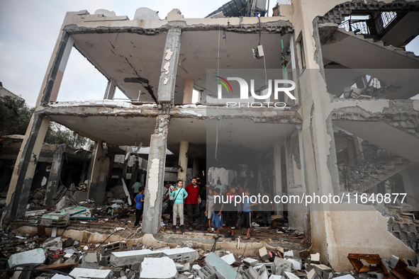 People inspect the damage to a mosque after it is hit in an Israeli strike in Deir al-Balah, central Gaza Strip, on October 6, 2024, amid th...