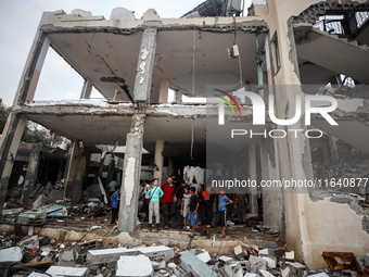 People inspect the damage to a mosque after it is hit in an Israeli strike in Deir al-Balah, central Gaza Strip, on October 6, 2024, amid th...