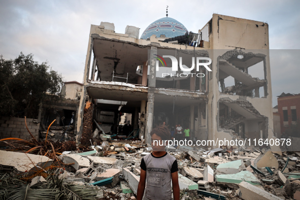 A Palestinian inspects the damage to a mosque after it is hit in an Israeli strike in Deir al-Balah, central Gaza Strip, on October 6, 2024,...