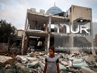 A Palestinian inspects the damage to a mosque after it is hit in an Israeli strike in Deir al-Balah, central Gaza Strip, on October 6, 2024,...