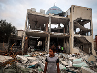 A Palestinian inspects the damage to a mosque after it is hit in an Israeli strike in Deir al-Balah, central Gaza Strip, on October 6, 2024,...