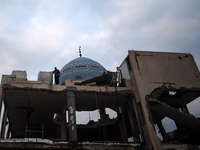 A Palestinian inspects the damage to a mosque after it is hit in an Israeli strike in Deir al-Balah, central Gaza Strip, on October 6, 2024,...