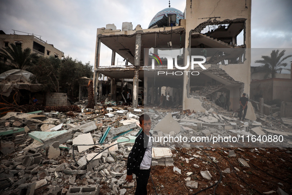 A Palestinian inspects the damage to a mosque after it is hit in an Israeli strike in Deir al-Balah, central Gaza Strip, on October 6, 2024,...