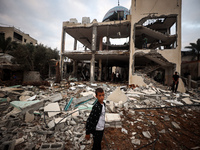 A Palestinian inspects the damage to a mosque after it is hit in an Israeli strike in Deir al-Balah, central Gaza Strip, on October 6, 2024,...