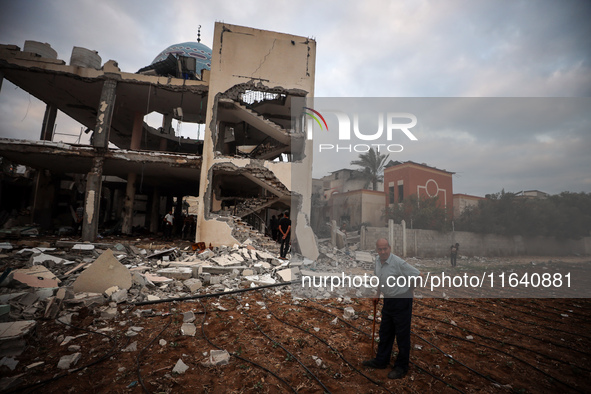 A Palestinian inspects the damage to a mosque after it is hit in an Israeli strike in Deir al-Balah, central Gaza Strip, on October 6, 2024,...