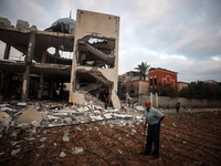 A Palestinian inspects the damage to a mosque after it is hit in an Israeli strike in Deir al-Balah, central Gaza Strip, on October 6, 2024,...