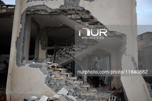 People inspect the damage to a mosque after it is hit in an Israeli strike in Deir al-Balah, central Gaza Strip, on October 6, 2024, amid th...