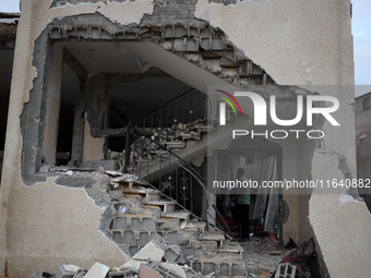 People inspect the damage to a mosque after it is hit in an Israeli strike in Deir al-Balah, central Gaza Strip, on October 6, 2024, amid th...