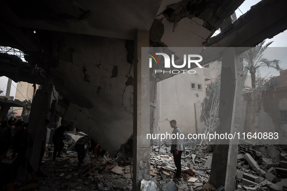 A Palestinian inspects the damage to a mosque after it is hit in an Israeli strike in Deir al-Balah, central Gaza Strip, on October 6, 2024,...