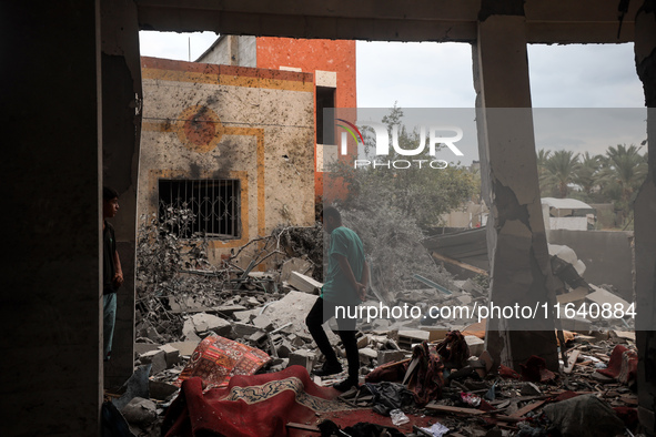 People inspect the damage to a mosque after it is hit in an Israeli strike in Deir al-Balah, central Gaza Strip, on October 6, 2024, amid th...