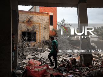 People inspect the damage to a mosque after it is hit in an Israeli strike in Deir al-Balah, central Gaza Strip, on October 6, 2024, amid th...