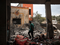 People inspect the damage to a mosque after it is hit in an Israeli strike in Deir al-Balah, central Gaza Strip, on October 6, 2024, amid th...