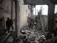 People inspect the damage to a mosque after it is hit in an Israeli strike in Deir al-Balah, central Gaza Strip, on October 6, 2024, amid th...