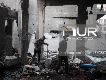 People inspect the damage to a mosque after it is hit in an Israeli strike in Deir al-Balah, central Gaza Strip, on October 6, 2024, amid th...