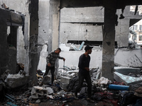 People inspect the damage to a mosque after it is hit in an Israeli strike in Deir al-Balah, central Gaza Strip, on October 6, 2024, amid th...