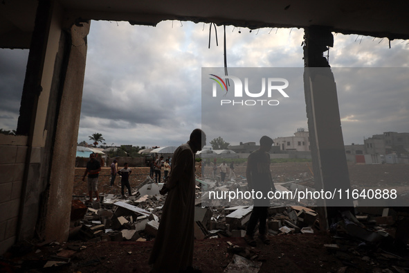 People inspect the damage to a mosque after it is hit in an Israeli strike in Deir al-Balah, central Gaza Strip, on October 6, 2024, amid th...