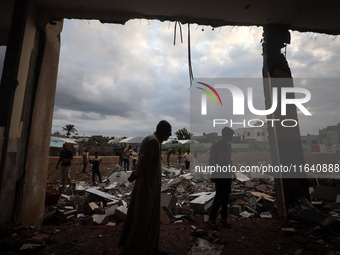 People inspect the damage to a mosque after it is hit in an Israeli strike in Deir al-Balah, central Gaza Strip, on October 6, 2024, amid th...