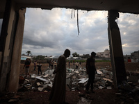 People inspect the damage to a mosque after it is hit in an Israeli strike in Deir al-Balah, central Gaza Strip, on October 6, 2024, amid th...