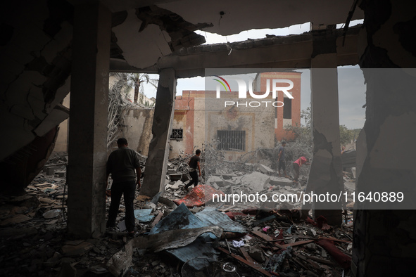 People inspect the damage to a mosque after it is hit in an Israeli strike in Deir al-Balah, central Gaza Strip, on October 6, 2024, amid th...