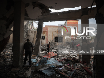 People inspect the damage to a mosque after it is hit in an Israeli strike in Deir al-Balah, central Gaza Strip, on October 6, 2024, amid th...