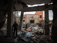 People inspect the damage to a mosque after it is hit in an Israeli strike in Deir al-Balah, central Gaza Strip, on October 6, 2024, amid th...