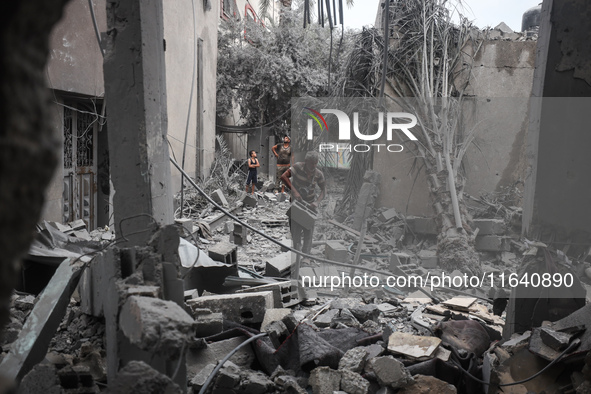 People inspect the damage to a mosque after it is hit in an Israeli strike in Deir al-Balah, central Gaza Strip, on October 6, 2024, amid th...