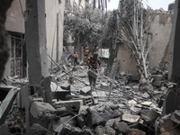 People inspect the damage to a mosque after it is hit in an Israeli strike in Deir al-Balah, central Gaza Strip, on October 6, 2024, amid th...