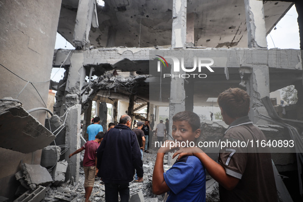 People inspect the damage to a mosque after it is hit in an Israeli strike in Deir al-Balah, central Gaza Strip, on October 6, 2024, amid th...